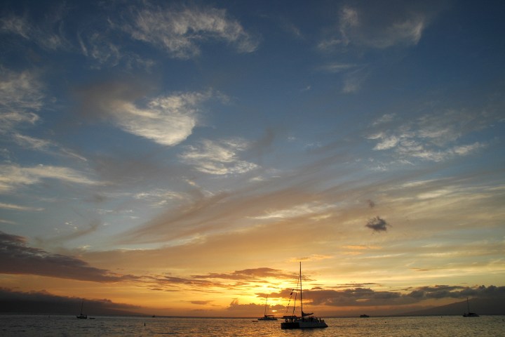 Sailboats silhouetted against a beautiful Kona sunset.