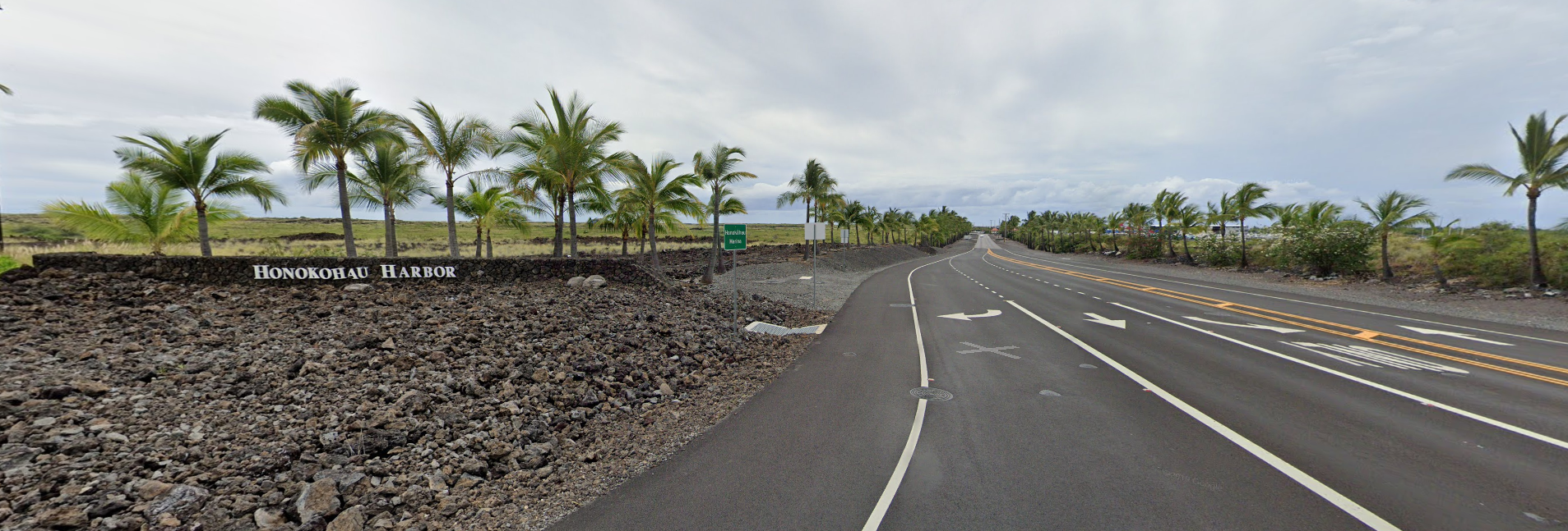 an empty road with trees in the background