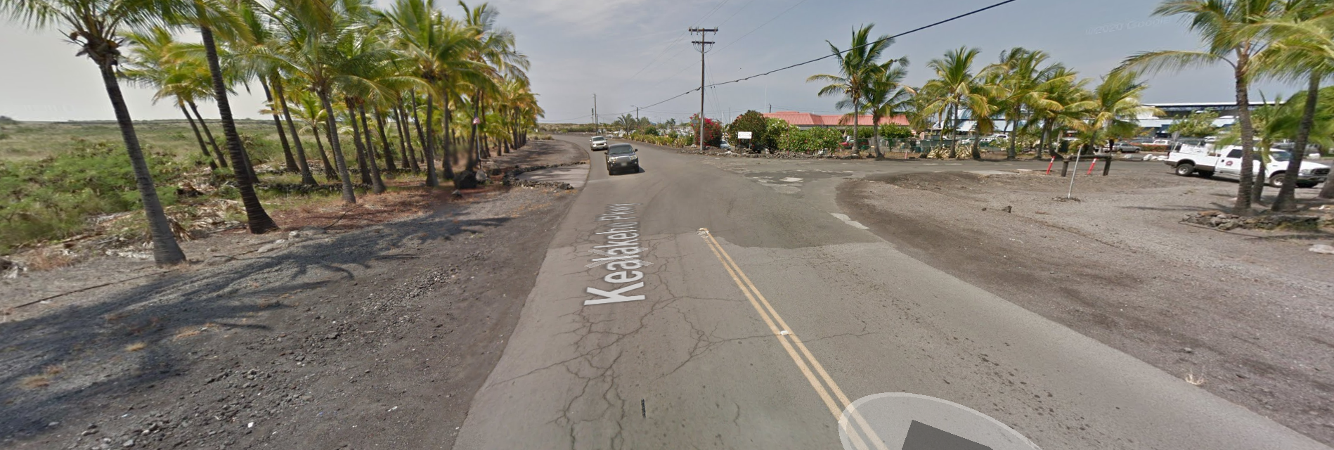 an empty road with trees on the side of the street